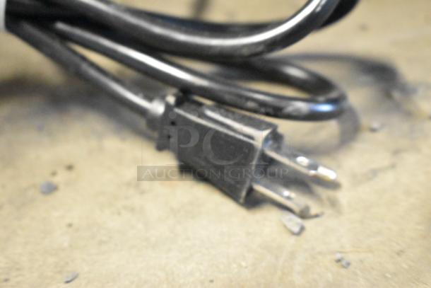 Close-up of the power cord plug for a Crathco CS-3L-16-290 refrigerated drink dispenser base.