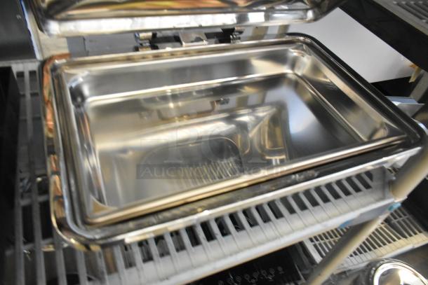 Brand new stainless steel chafer with minor scratches and dents. Shiny surface, open lid, ideal for catering use.