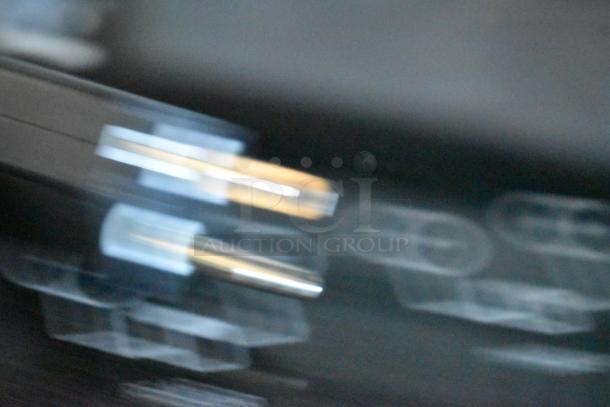 Blurry close-up image likely related to a 2024 Avantco 177ID18DB induction range's component, focusing on metal and plastic parts.
