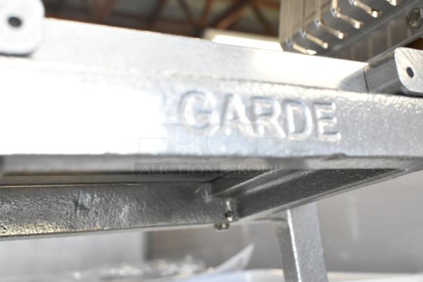 BRAND NEW SCRATCH AND DENT Garde CHKSLC12 1/2" serrated blade chicken slicer, visible Garde branding, metal frame condition.