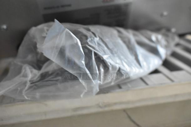 Brand new Avantco 177IC3500 countertop induction range wrapped in plastic, showing scratch and dent condition. 208-240V, 1 phase.