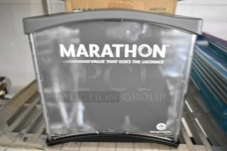 BRAND NEW Marathon 6407124 Interfold Napkin Dispenser, scratch and dent condition, black with branding visible.