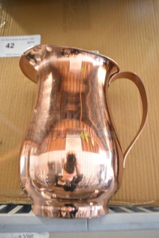 Brand new Acopa 64 oz. satin copper stainless steel slender bell pitcher, slightly scratched, reflective finish, ergonomic handle.