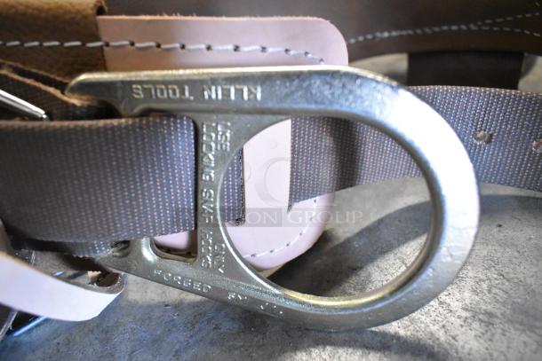 Klein Tools 5268N23D Body Belt, new condition, featuring locking snap hook. Marked "FORGED SN USA" and "USE LOCKING SNAP HOOK ONLY".