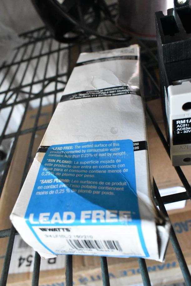 Three scratch and dent items, including Watts 3/4 LF10L-2 package, "Lead Free" label visible, RM1A23D50 heating element.