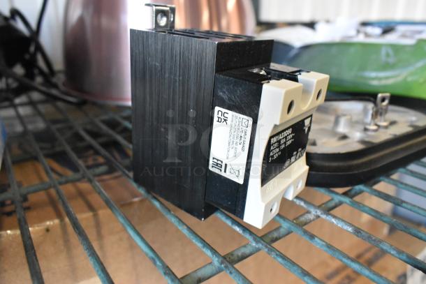3 new scratch and dent items including Watts 3/4 LF10L-2, RM1A23D50 relay, and heating element on metal shelf.