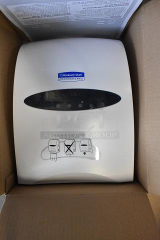 Brand new Kimberly-Clark 09991 towel dispenser, scratch and dent, with instructional graphics on front, in original packaging.