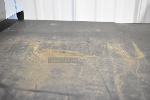 Rusted and scratched metal surface of the True GDM-41SL-60-LD cooler. Signs of wear and age.