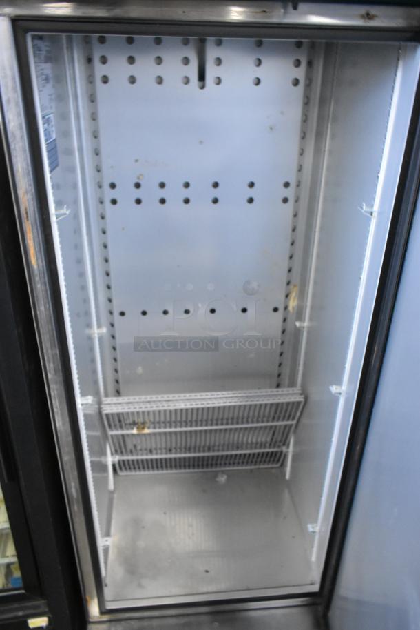 2022 True T-19F-HC stainless steel commercial freezer, single door, interior shown empty. Model details and 115V label visible.
