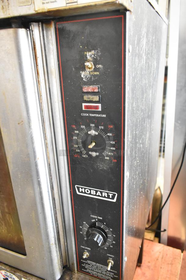 Hobart HGC5-11D3 commercial convection oven with thermostatic controls, view-through doors, and metal racks. Slight wear visible.