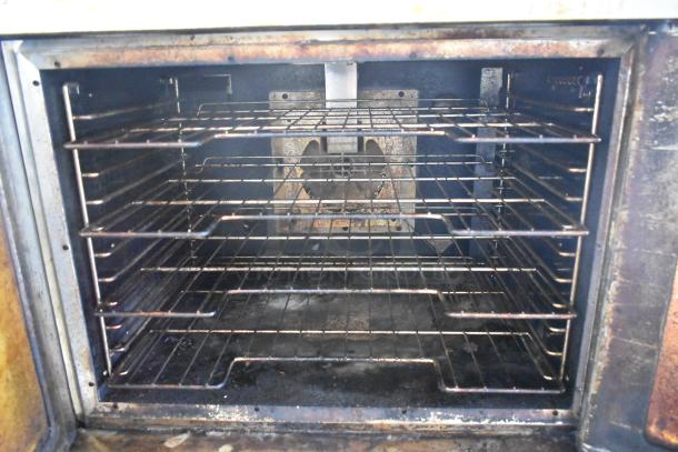 Hobart HGC5-11D3 stainless steel convection oven interior with metal racks, showing view-through doors and thermostatic controls.