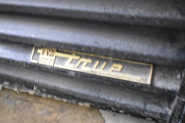 True GDM-41SL-60-LD cooler with visible model label, showing wear. Black metal finish, 115V, 1-phase, poly-coated racks.