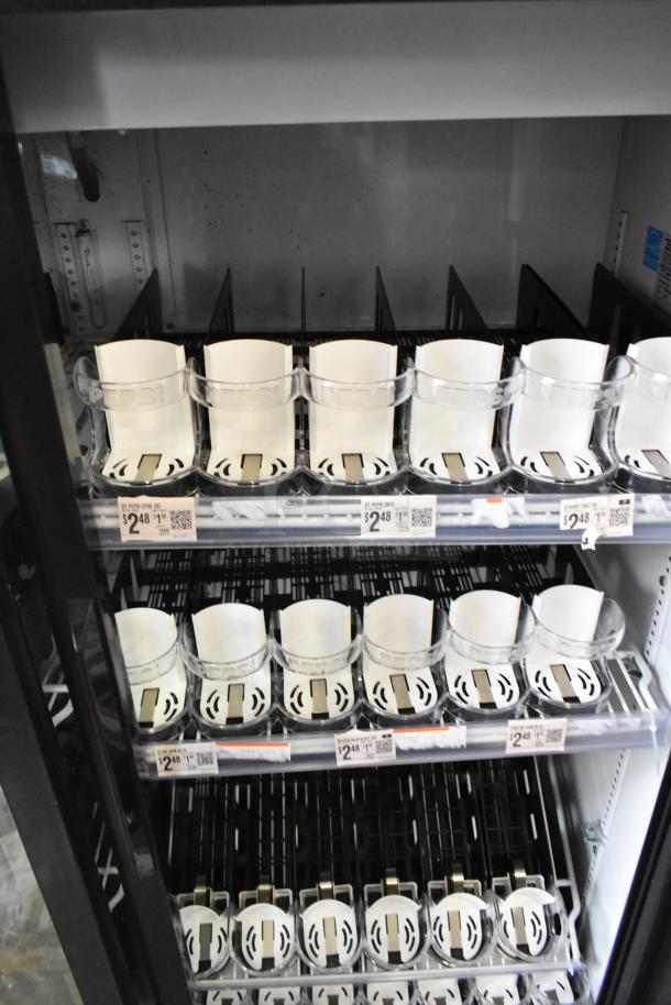 True GDM-41SL-60-LD commercial cooler, two-door, metal, poly-coated racks, shows price tags for Pepsi bottles.