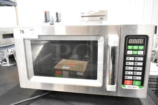 Winco EMW-1000ST stainless steel commercial microwave, brand new with scratches and dents. 120V, 1 phase. Auction tag visible.