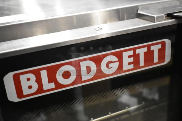 Blodgett Hydrovection Helix stainless steel commercial convection oven with view-through doors and metal racks, close-up on logo.
