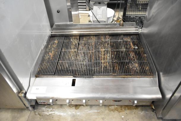 APW Wyott stainless steel gas-powered countertop charbroiler grill, used condition, visible controls, and grill marks.