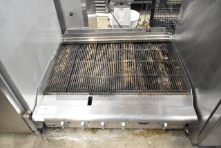 APW Wyott stainless steel gas-powered countertop charbroiler grill, used condition, visible controls, and grill marks.