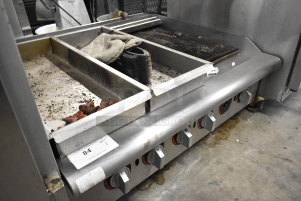 APW Wyott stainless steel commercial countertop gas charbroiler grill with control knobs, showing signs of use.