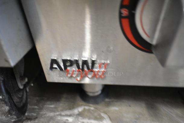APW Wyott stainless steel commercial charbroiler grill, gas-powered, countertop design, logo visible, good condition.