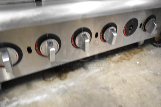 APW Wyott stainless steel gas charbroiler grill, commercial countertop model, multiple control knobs shown, used condition.