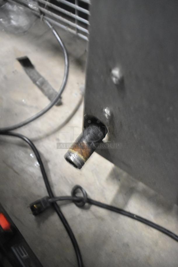 APW Wyott Stainless Steel Commercial Gas Charbroiler, showing gas connection and power cord, some wear visible.