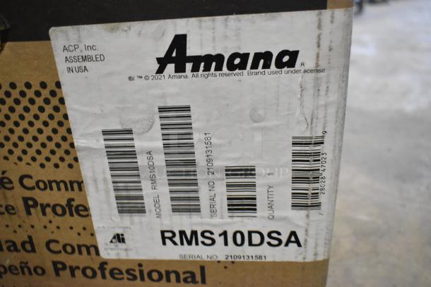 Brand new 2021 Amana RMS10DSA stainless steel commercial microwave in box, 120V, 1 phase, model and serial labels visible.