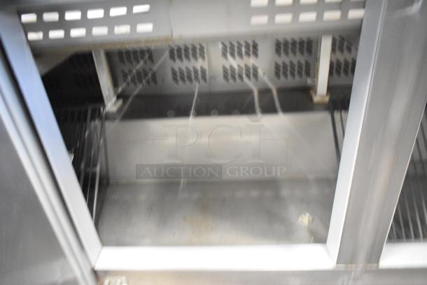 2019 Berg EDMT 72 30 Stainless Steel Prep Table, Mega Top, on casters, 115V, 1 Phase, interior view showing shelves.