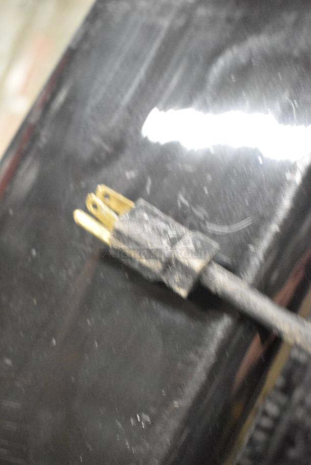 Close-up of a worn electrical plug from a 2019 Berg EDMT 72 30 BERG commercial prep table, emphasizing its used condition.