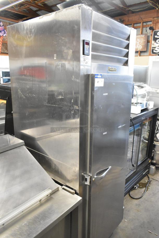 Traulsen AHT132WUT-FHS stainless steel commercial single-door reach-in cooler with racks, 115V, 1 phase, visible wear.