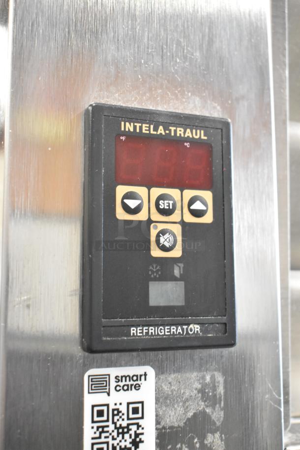 Traulsen AHT132WUT-FHS cooler control panel with Intela-Traul display, temperature settings, and Smart Care QR code on stainless steel surface.