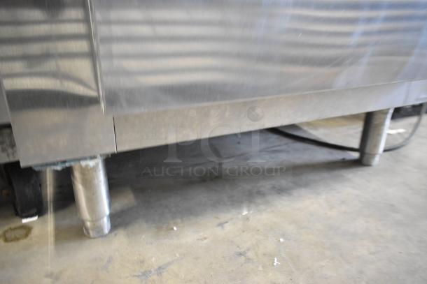 Traulsen AHT132WUT-FHS stainless steel commercial reach-in cooler, visible lower section, sturdy legs, suitable for professional kitchens.