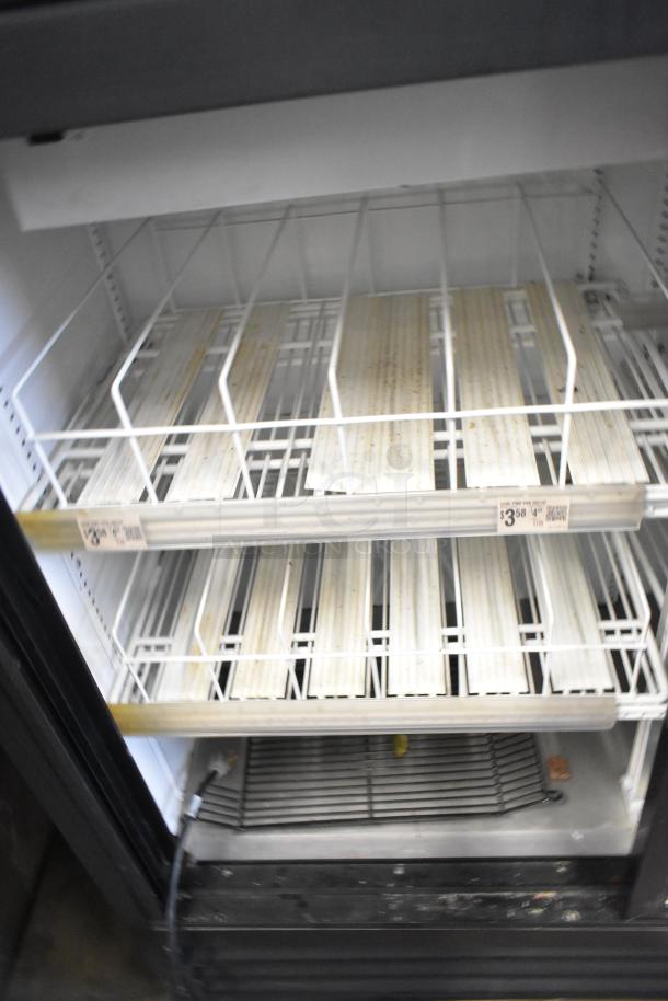 2019 True GDM-41SL-48-HC-LD cooler with two doors, poly-coated racks, 115V, 1 phase; shows interior condition and shelving.