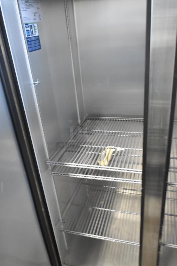 2021 True T-35-HC stainless steel 2-door reach-in cooler; features poly-coated racks, 115V, 1-phase; excellent condition.