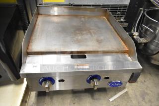 Globe GG24G stainless steel countertop gas griddle, 60,000 BTU. Dual dials, branding on the front. Used condition.