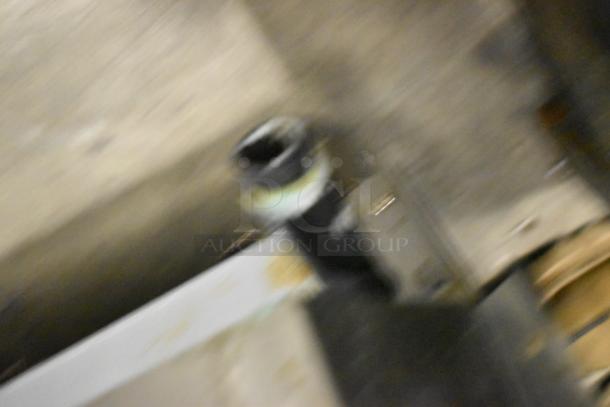 The image is blurry and does not clearly show the item. The auction item is a Globe GG24G Stainless Steel Commercial Countertop Gas Flat Top Griddle, 60,000 BTU.