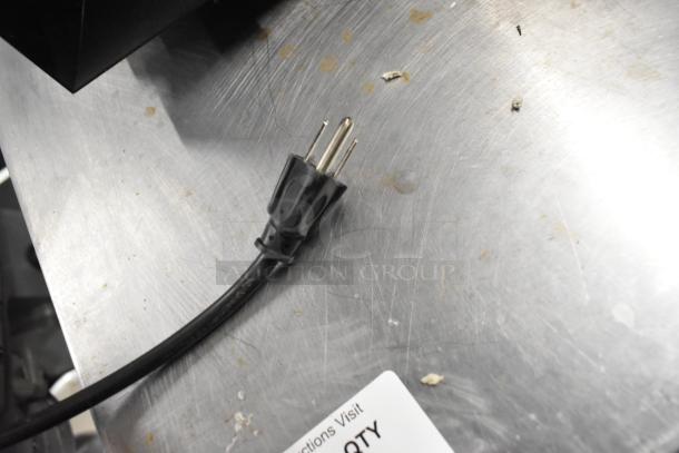 2019 IDW G4-H0234B metal mini cooler merchandiser plug, 110-120 volts, single phase. Black cord on metallic surface.
