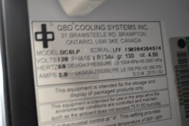 Label on QBD DC6LP Metal Mini Cooler Merchandiser showing model, voltage, and serial number. 110-120 volts, 1 phase.