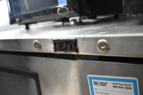 True TUC-48F-LP undercounter freezer in stainless steel. Features 2 doors, commercial grade, 115V, 1 phase. Visible wear.