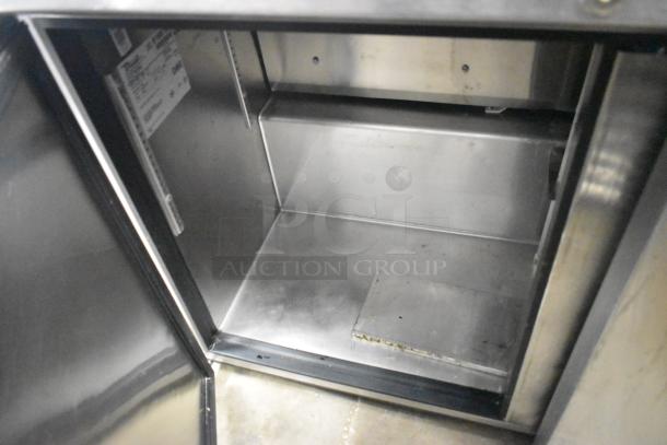 True TUC-48F-LP stainless steel undercounter freezer interior. Features dual doors, visible label, 115V, 1 phase.