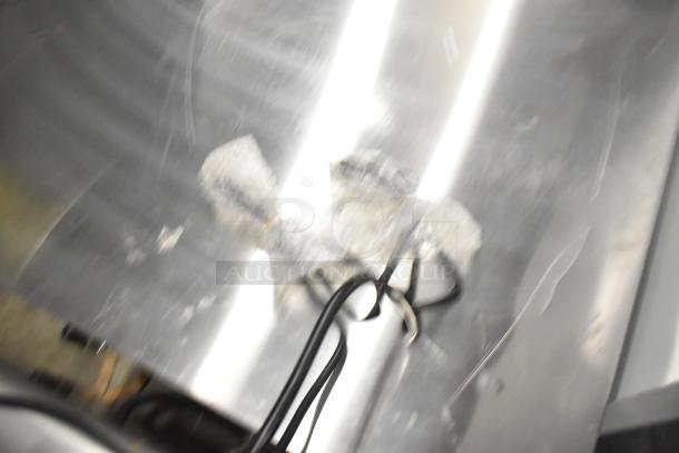 Blurry image of a Carnival King waffle maker model 382WBM26DGT, with packaging material and power cord visible.