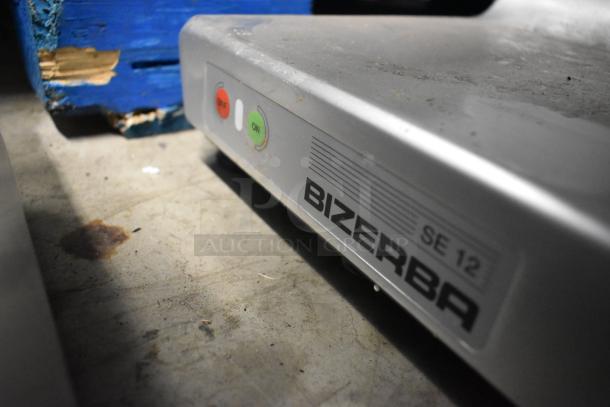 Bizerba SE 12 US metal commercial countertop meat slicer. Features on/off buttons, 120 volts, 1 phase, slight wear visible.