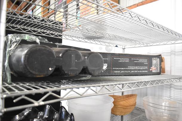 Metro lot of various items includes plates, bowls, and a poly bin on metal shelves. Items are in used condition. Shelving unit not included.