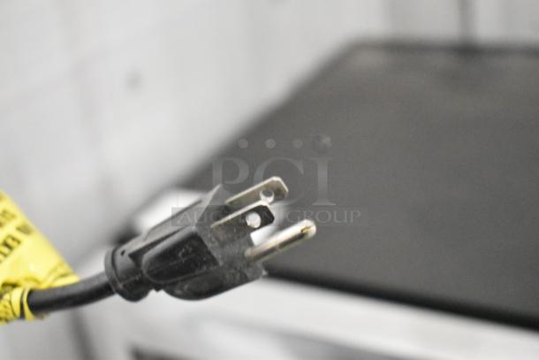 2019 IDW G4-HD234B mini cooler power cord, 115V, 1-phase, close-up of plug with yellow label.