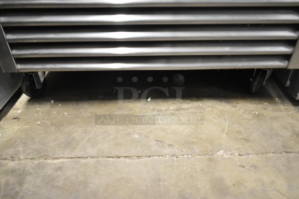 2017 True T-35 stainless steel reach-in cooler base with commercial casters, showing vented front panel.