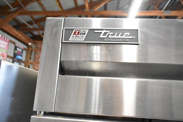 2017 True T-35 stainless steel commercial cooler, 2 doors, poly racks, commercial casters, label shows "True Refrigerator."