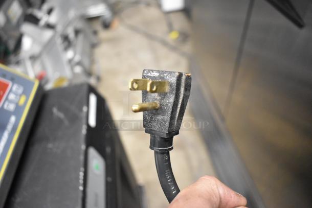 Close-up of a three-prong power plug for the 2017 True T-35 Commercial Cooler, showing plug details and wear.