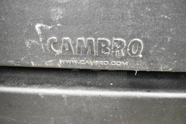 Cambro logo on black poly heated holding cabinet with visible wear, model features two compartments for optimal food storage.