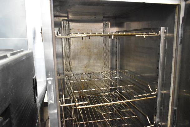 Wittco 1200-2E1ZN stainless steel heated holding cabinet, interior view. Visible wire racks and perforated panels.