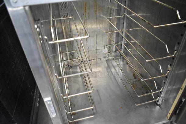 Wittco 1200-2E1ZN stainless steel heated holding cabinet, commercial casters, 208-240 volts, interior racks visible.