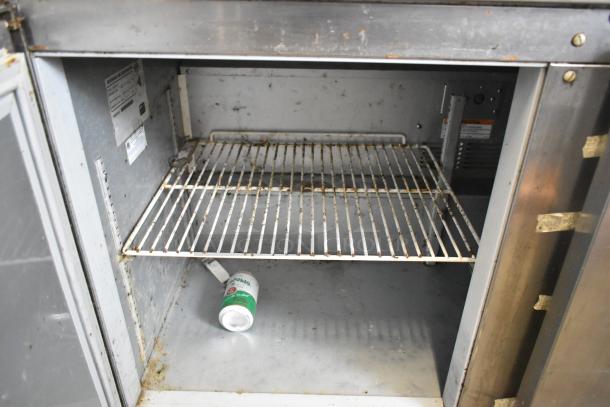 Beverage Air UCR72AY-23 stainless steel undercounter cooler with visible interior wear, open door displays shelving.